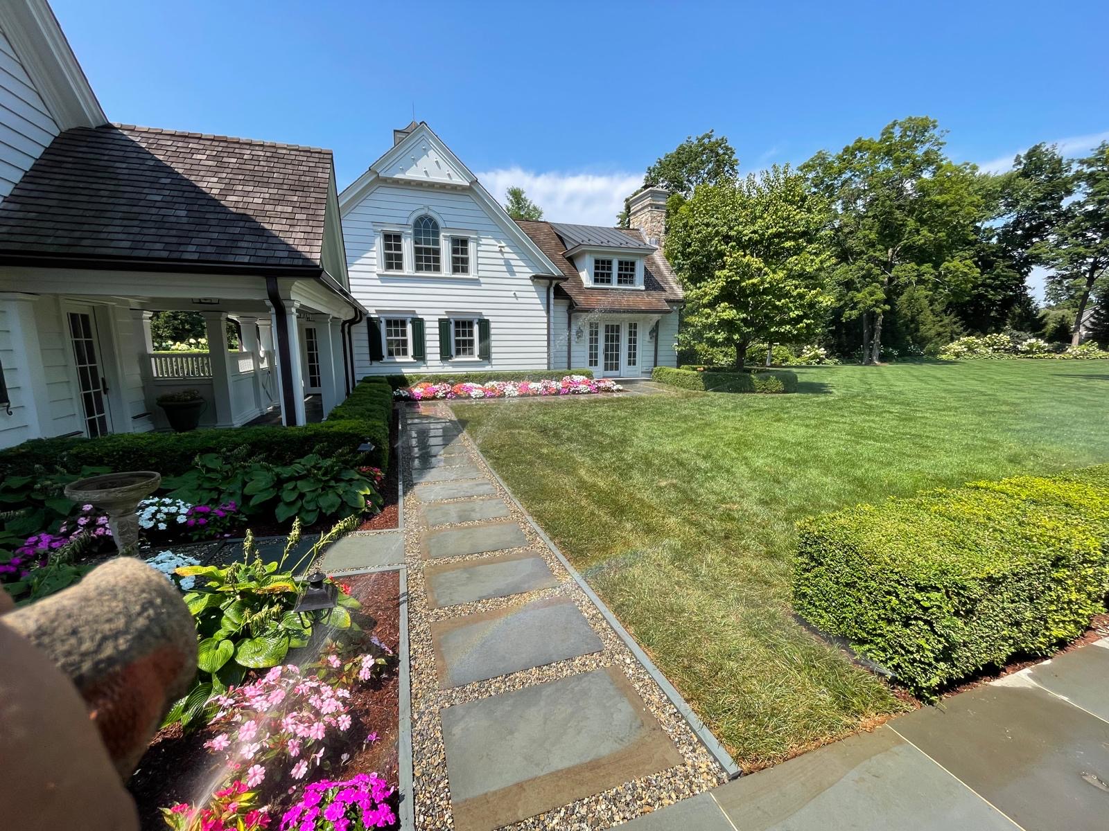 Newly installed foundation plantings and boxwood hedges at a luxury New Jersey home