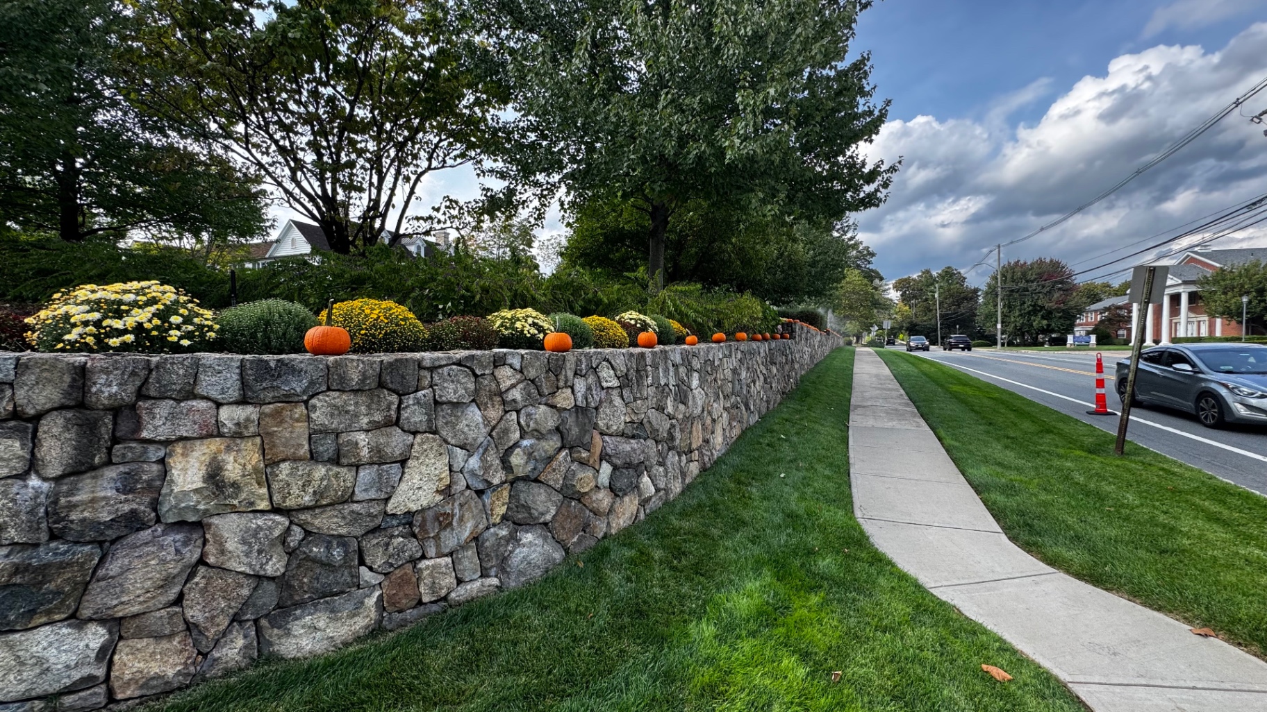 Tiered natural stone retaining wall terracing a sloped residential yard